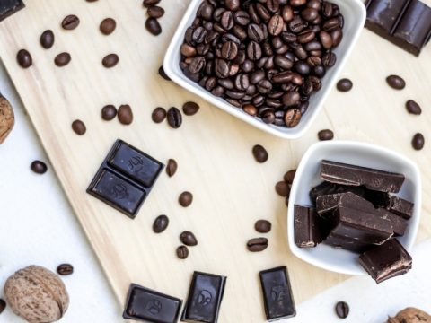 chocolate and coffee seeds on table near bowls