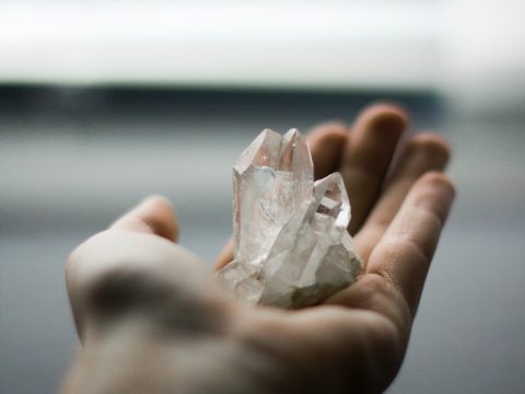 person holding crystal stones