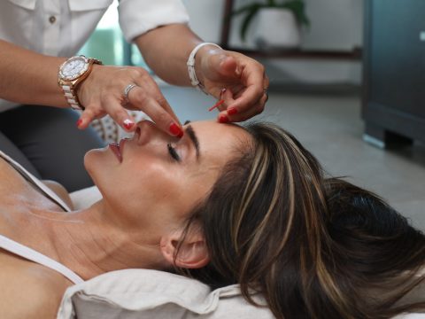 person holding woman nose