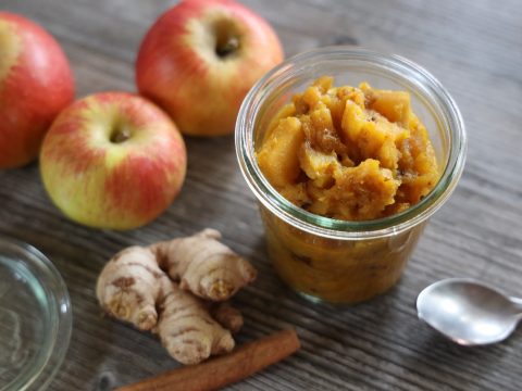 ginger near stainless steel spoon, three apple fruits, and cinnamon