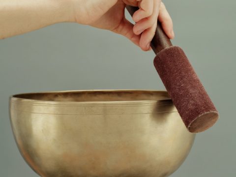 person holding brown clay pot